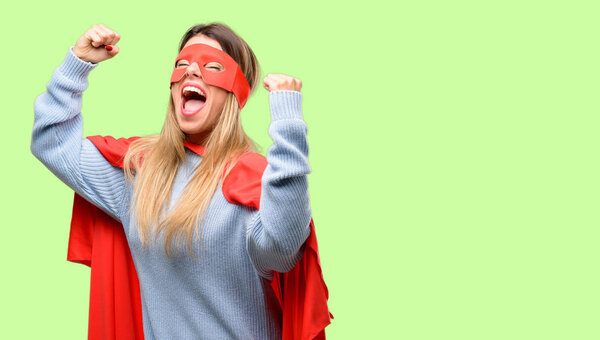 Young super woman happy and excited celebrating victory expressing big success, power, energy and positive emotions. Celebrates new job joyful