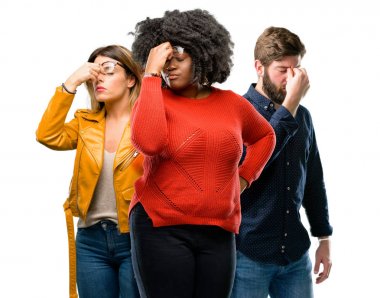 Grup üç genç erkek ve kadınların aşırı ve yorgun, uykulu ifade ile rubbes yorgunluk nedeniyle burun.