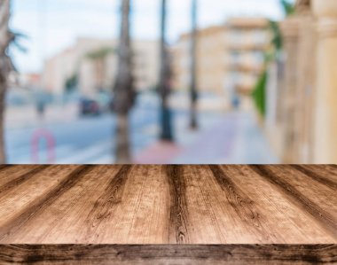 Wooden empty table board in front of blurred background. Can be  clipart