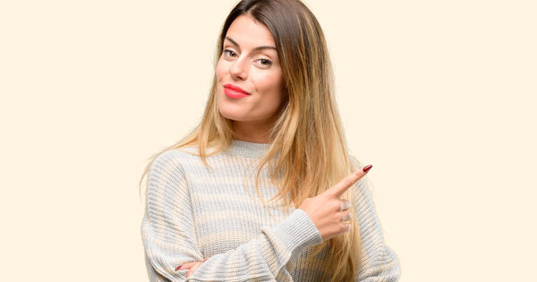 Young beautiful woman pointing away side with finger