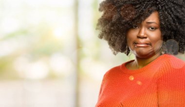 Beautiful african woman feeling disgusted with tongue out, outdoor clipart