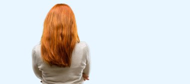 Güzel genç Kızıl saçlı kadın arka, dikiz mavi arka plan izole