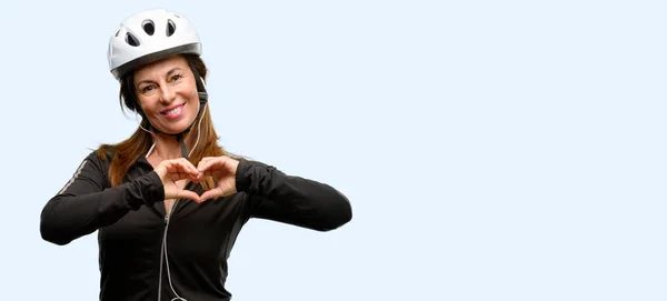 Middle Age Cyclist Woman Using Earphones Happy Showing Love Hands — Stock Photo, Image