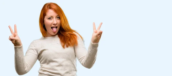 Beautiful Young Redhead Woman Looking Camera Showing Tong Making Victory — Stock Photo, Image