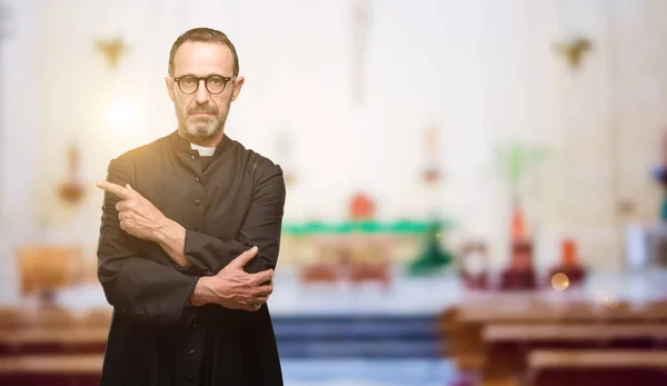 Priest religion man pointing away side with finger at church