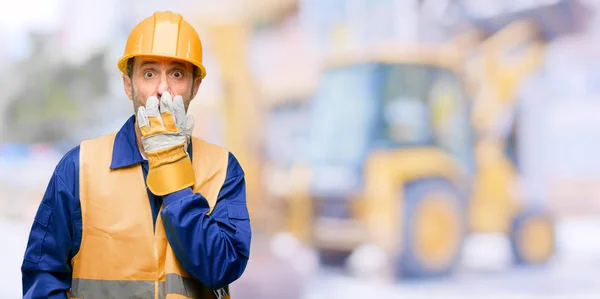 Senior Engineer Man Construction Worker Covers Mouth Shock Looks Shy — Stock Photo, Image