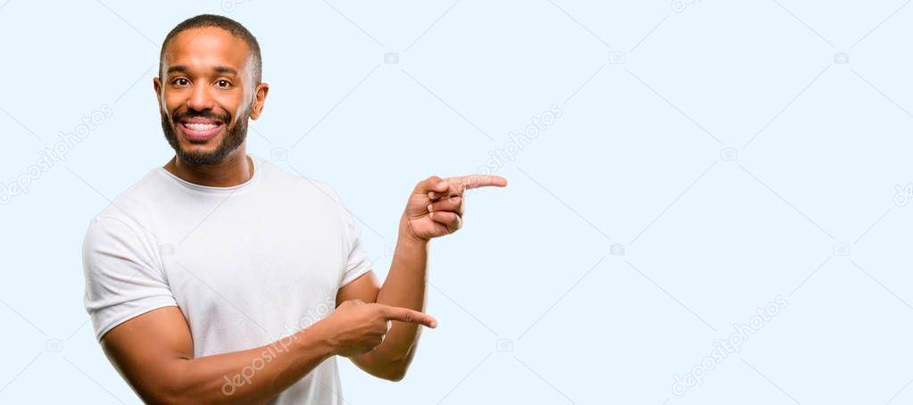 African american man with beard pointing away side with finger isolated over blue background