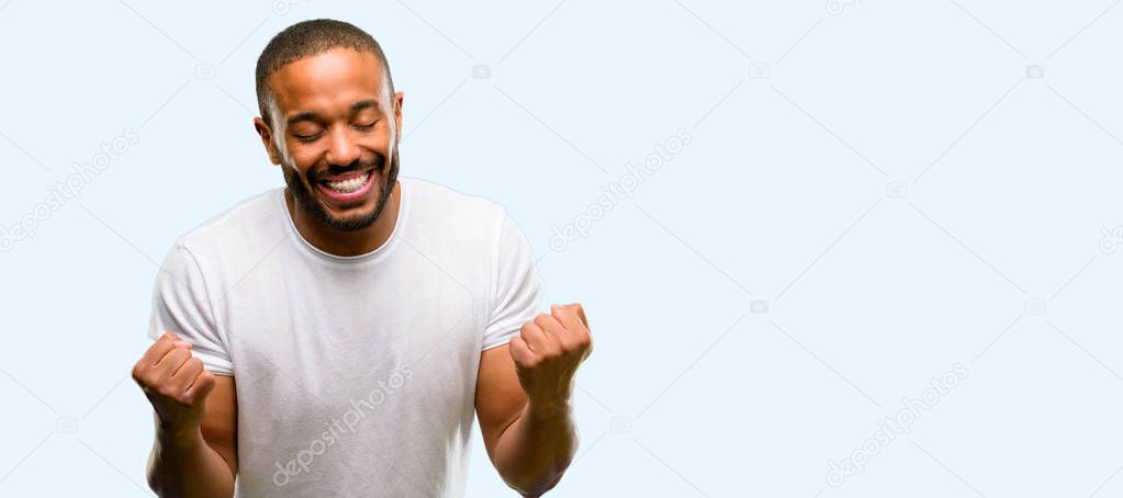African american man with beard happy and excited celebrating victory expressing big success, power, energy and positive emotions. Celebrates new job joyful isolated over blue background