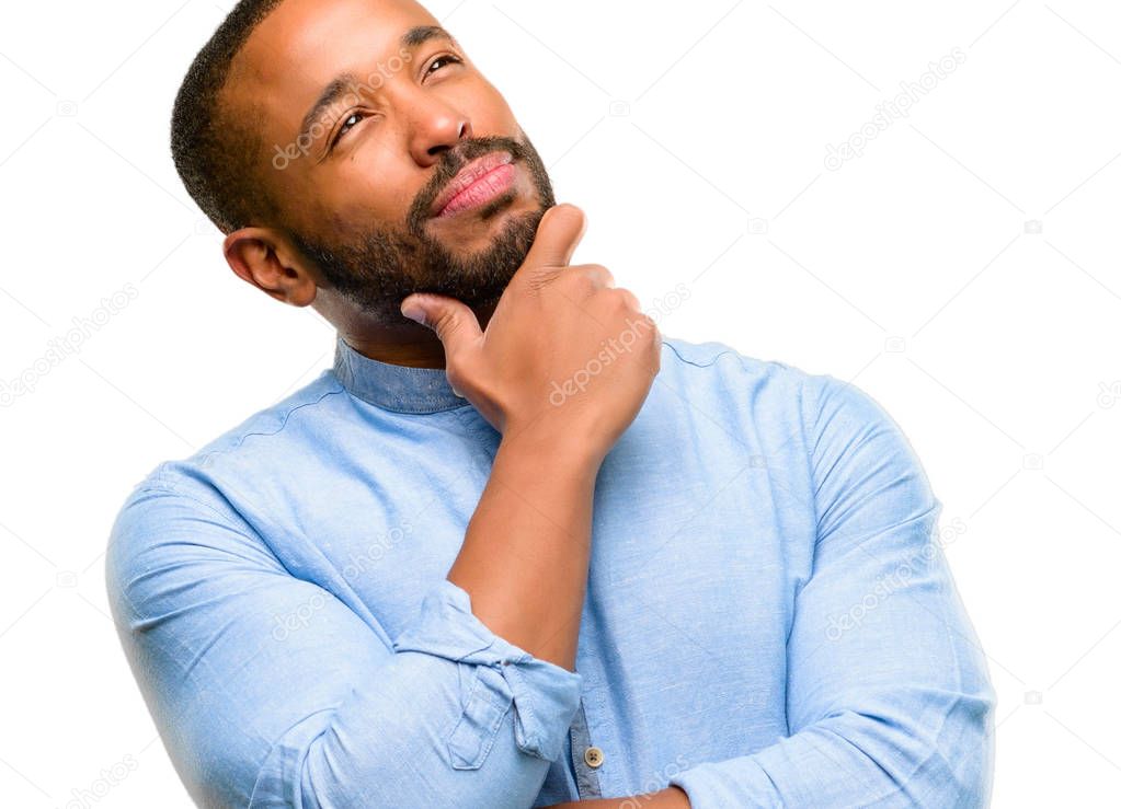 African american man with beard thinking and looking up expressing doubt and wonder isolated over white background