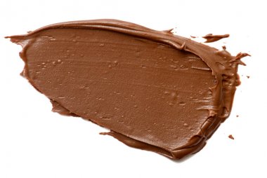 Krem çikolata üzerinde beyaz artalanları izole yayılıyor. Gıda ba