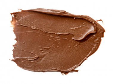 Krem çikolata üzerinde beyaz artalanları izole yayılıyor. Gıda ba