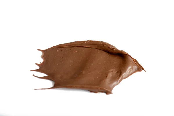 Creme chokolade spreder sig isoleret over hvid baggrund. Fødevarer - Stock-foto