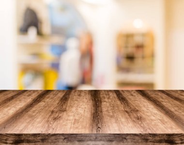 Wooden empty table board in front of blurred background. Can be  clipart