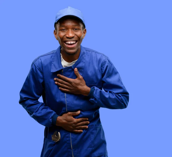 African black plumber man confident and happy with a big natural smile laughing