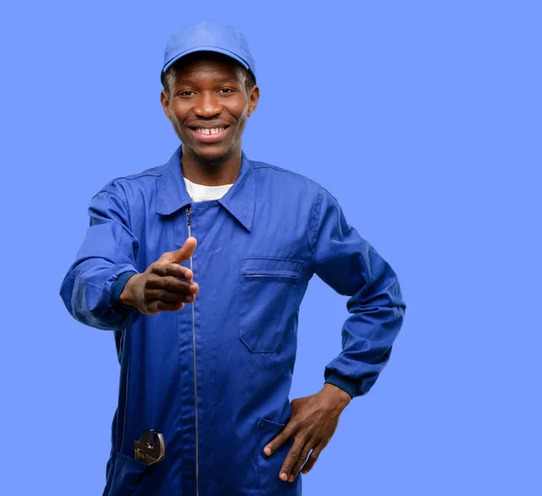 African black plumber man holds hands welcoming in handshake pose, expressing trust and success concept, greeting