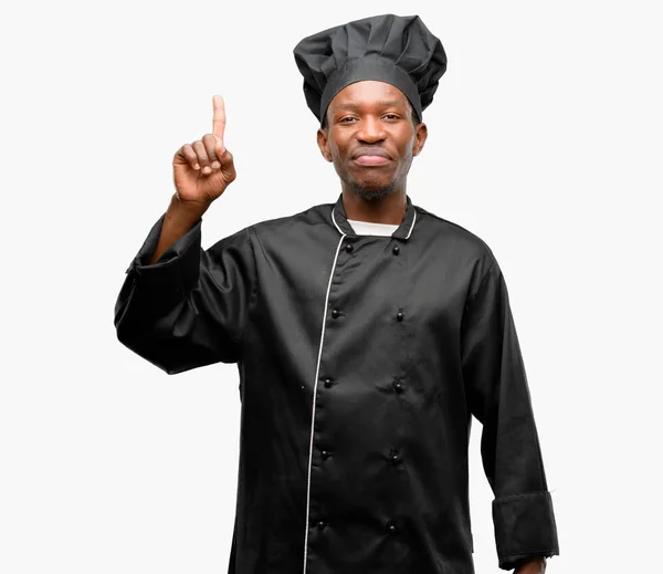 Young Black Cook Wearing Chef Hat Raising Finger Number One — Stock Photo, Image