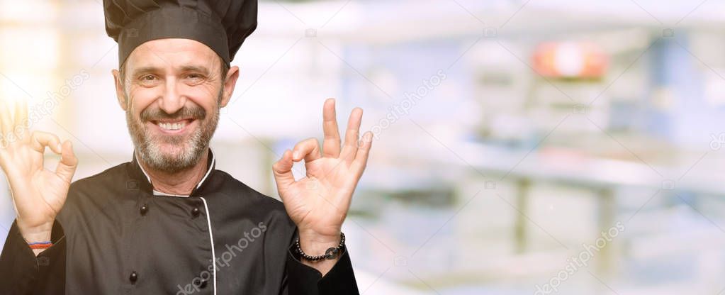 Senior cook man, wearing chef hat doing ok sign gesture with both hands expressing meditation and relaxation at restaurant kitchen
