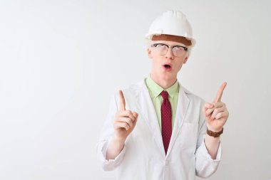 Gözlüklü ve kasklı albino bilimadamı izole edilmiş beyaz arka planda duruyordu. Şaşırmış ve şaşırmıştı. Parmaklarıyla işaret edip kollarını kaldırıyordu..