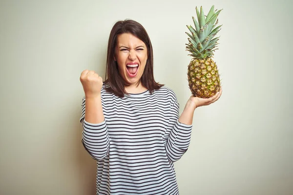 Young Beautiful Woman Holding Tropical Fruit Pineapple Isolated Background Screaming — Stock Photo, Image