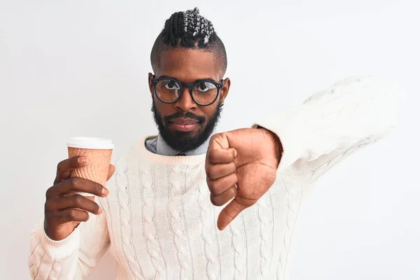 African american man with braids drinking take away coffee over isolated white background with angry face, negative sign showing dislike with thumbs down, rejection concept