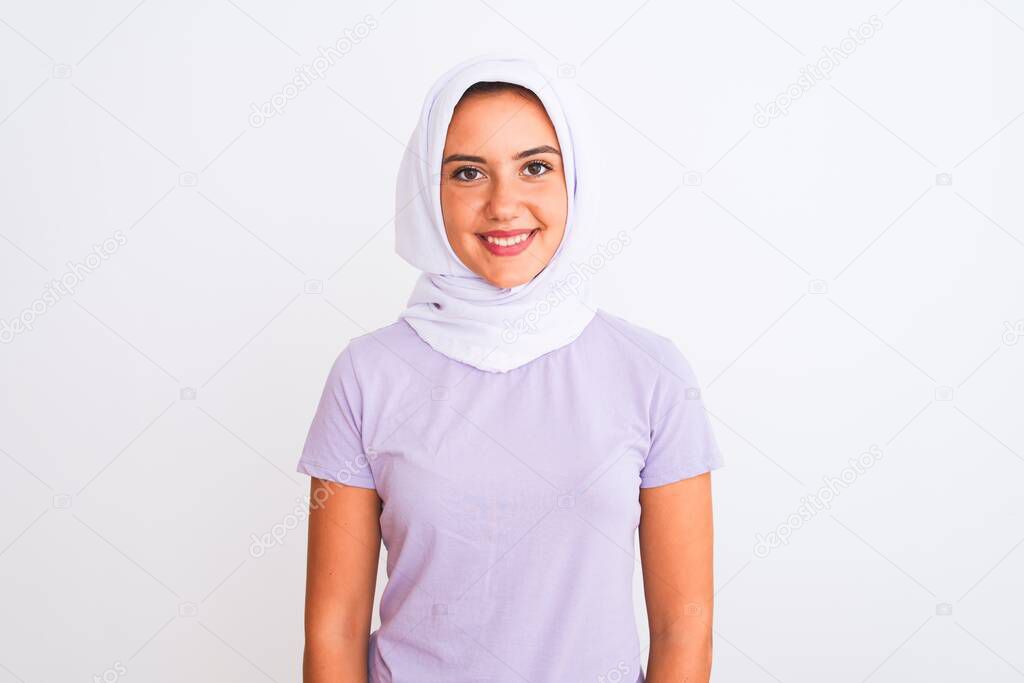 Young beautiful arabian girl wearing hijab standing over isolated white background with a happy and cool smile on face. Lucky person.