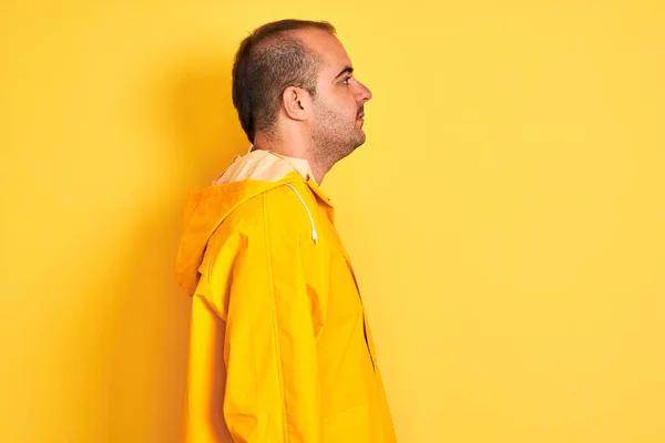Young Man Wearing Rain Coat Standing Isolated Yellow Background Looking — Stock Photo, Image
