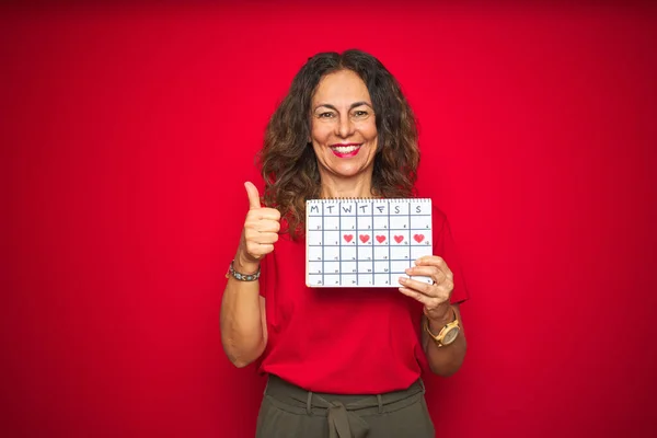 Middle Age Senior Woman Holding Menstruation Calendar Red Isolated Background — Stock Photo, Image