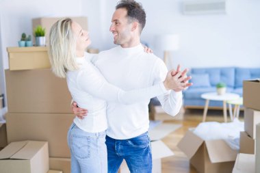 Karton kutular etrafında yeni evde dans genç güzel çift