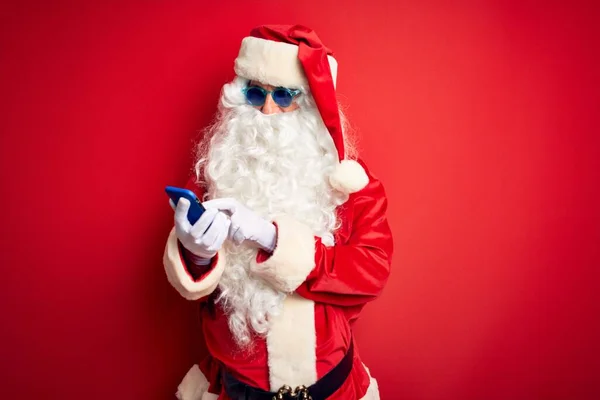 Senior Man Wearing Santa Claus Costume Using Smartphone Isolated Red — Stock Photo, Image