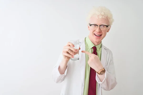 Albino scientist man wearing glasses holding glass of water over isolated white background very happy pointing with hand and finger