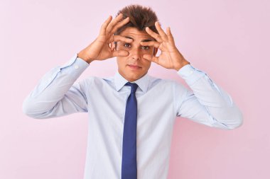 Genç yakışıklı iş adamı gömlek ve kravat takıyor pembe arka planda dikiliyor parmaklarıyla gözlerini açmaya çalışıyor, uykulu ve yorgun bir şekilde sabah yorgunluğu çekiyor.