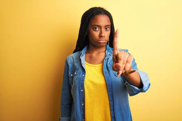 Молодая Африканская Американка Джинсовой Рубашке Стоящая Изолированном Жёлтом Фоне Показывая — стоковое фото