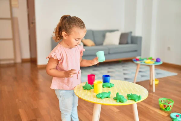 Beautiful Blond Toddler Girl Playing Plastic Frogs Toys Kindergarten — Stock Photo, Image