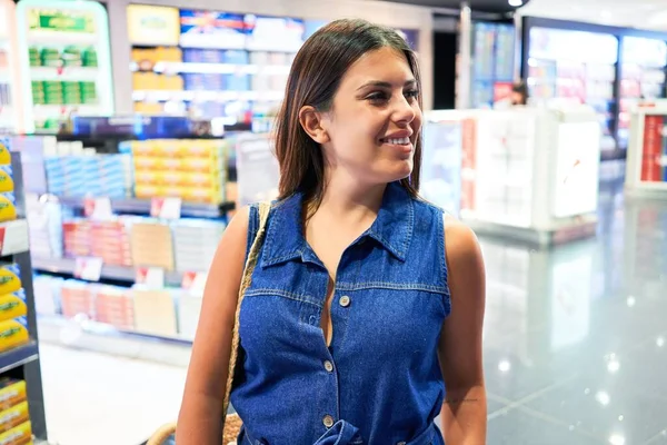 Young traveller woman at the tax free shop at the airport