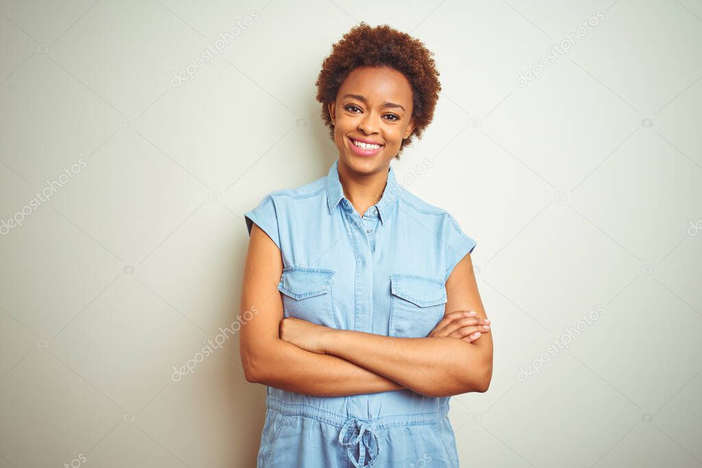 Young beautiful african american woman with afro hair over isolated background happy face smiling with crossed arms looking at the camera. Positive person.