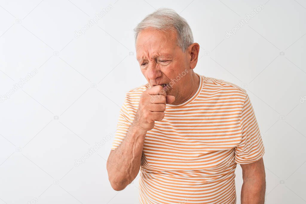Senior grey-haired man wearing striped t-shirt standing over isolated white background feeling unwell and coughing as symptom for cold or bronchitis. Healthcare concept.