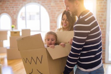 Güzel famiily, yeni evde bel karton kutu sürme ailesi ile oynayan çocuk