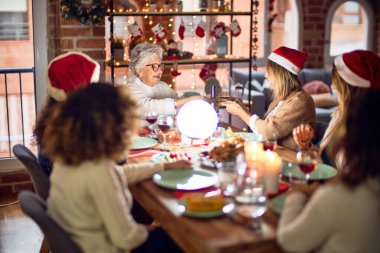 Mutlu ve kendinden emin gülümseyen güzel bir kadın grubu. Evde kızarmış hindi yiyip Noel 'i kutluyoruz.