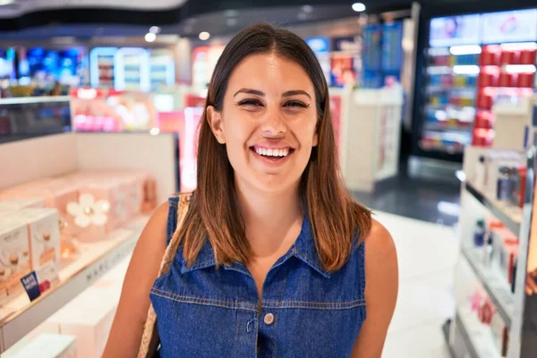 Young traveller woman at the tax free shop at the airport