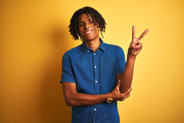 Afro Man Dreadlocks Wearing Casual Denim Shirt Standing Isolated Yellow — Stock Photo, Image