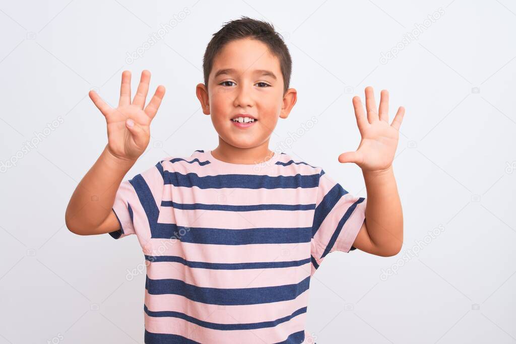 Beautiful kid boy wearing casual striped t-shirt standing over isolated white background showing and pointing up with fingers number nine while smiling confident and happy.