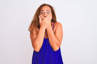 Orta yaşlı olgun bir kadın beyaz arka planda dikiliyor. Ağzını yanlışlıkla ellerinle kapatıyor. Gizli konsept.