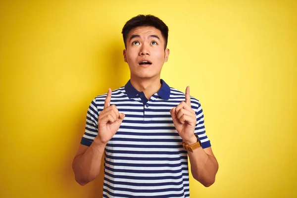 Young Asian Chinese Man Wearing Striped Polo Standing Isolated Yellow — Stock Photo, Image