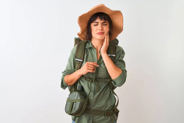 Hiker woman wearing backpack hat and water canteen over isolated white background touching mouth with hand with painful expression because of toothache or dental illness on teeth. Dentist concept.