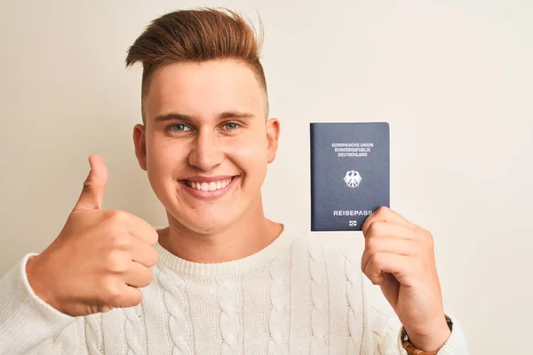 Joven Hombre Guapo Sosteniendo Alemania Pasaporte Alemán Sobre Fondo Blanco —  Fotos de Stock