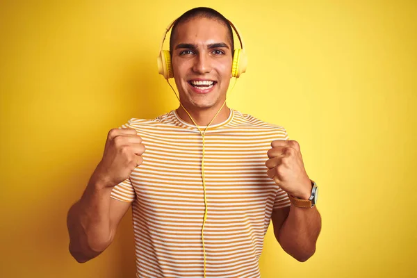 Young Handsome Man Using Headphones Yellow Isolated Background Celebrating Surprised — Stock Photo, Image