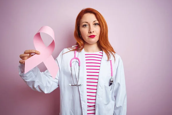 Junge Rothaarige Ärztin Hält Krebsband Über Rosa Isoliertem Hintergrund Mit — Stockfoto