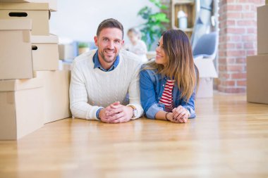 Karton kutular etrafında yeni evde yatan çocuk ile güzel famiily