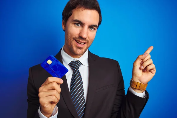 Young Handsome Businessman Holding Credit Card Standing Isolated Blue Background — Stock Photo, Image