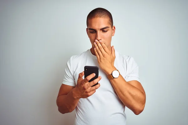 Young Handsome Man Using Smartphone Yellow Isolated Background Cover Mouth — ストック写真